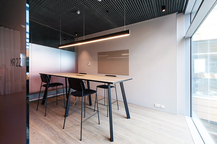 Subtle stickering envelops this meeting room in a Unilin-branded, warm beige glow
